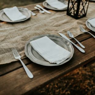 Assiettes et couverts sur table en bois et nappe